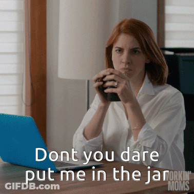 A Woman Sitting At A Desk With A Laptop And A Cup Of Coffee Says " Dont You Dare Put Me In The Jar GIF