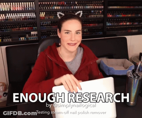 A Woman Sitting At A Desk With A Laptop And The Words " Enough Research " On The Bottom GIF