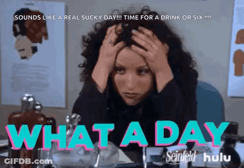A Woman Sitting At A Desk With Her Hands On Her Head And The Words What A Day GIF
