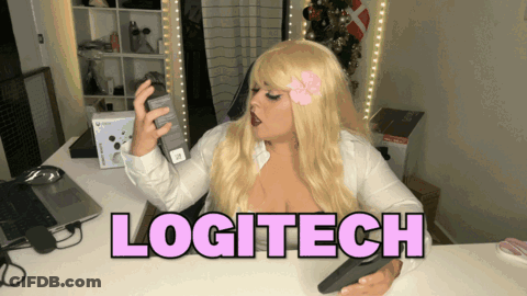 A Woman Sitting At A Desk With The Word Logitech In Pink GIF