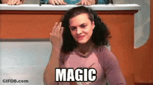 A Woman Sitting At A Desk With The Word Magic Written On Her Shirt GIF