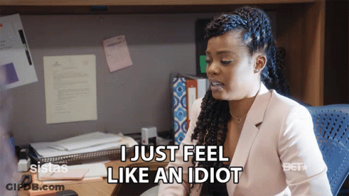 A Woman Sitting At A Desk With The Words I Just Feel Like An Idiot GIF