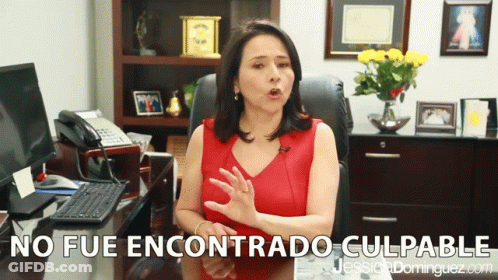 A Woman Sitting At A Desk With The Words No Fue Encontrado Culpable In The Corner GIF