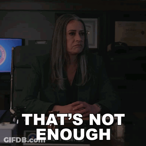 A Woman Sitting At A Desk With The Words That 'S Not Enough GIF
