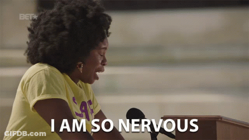 A Woman Sitting At A Podium With The Words I Am So Nervous Below Her GIF