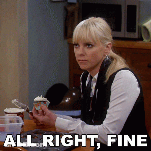 A Woman Sitting At A Table With A Cupcake And The Words All Right Fine GIF