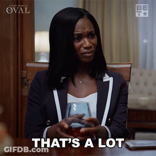 A Woman Sitting At A Table With A Glass Of Wine And The Words That 'S A Lot GIF