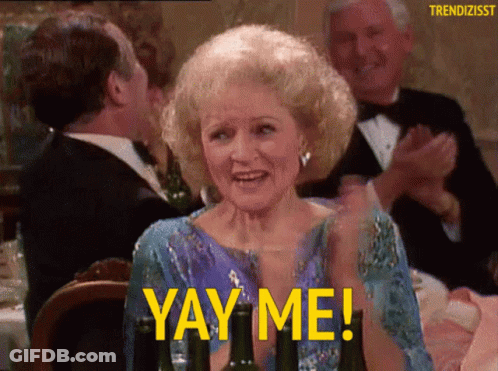 A Woman Sitting At A Table With A Glass Of Wine And The Words Yay Me GIF