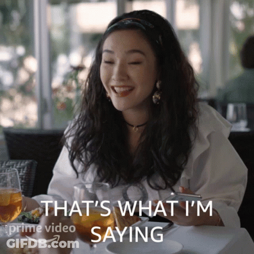 A Woman Sitting At A Table With A Glass Of Wine Says That 'S What I 'M Saying On The Bottom GIF