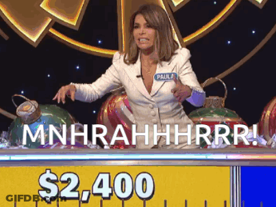 A Woman Sitting At A Table With A Sign That Says $ 2,400 On It GIF