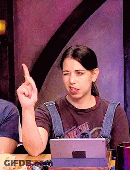 A Woman Sitting At A Table With A Tablet And A T-Shirt That Says ' Ariel ' On It GIF
