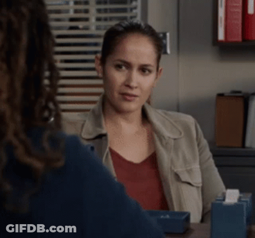 A Woman Sitting At A Table With A Tissue Box In Front Of Her GIF
