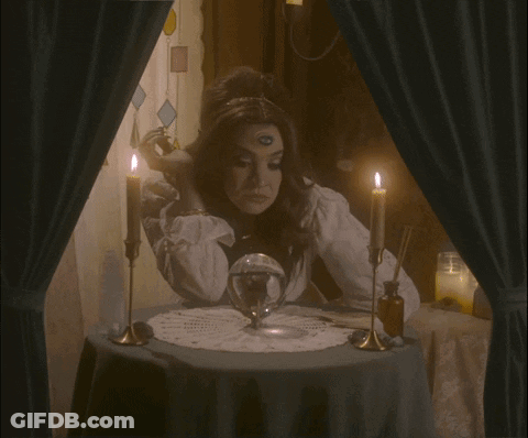A Woman Sitting At A Table With Candles And The Words The Audacity GIF