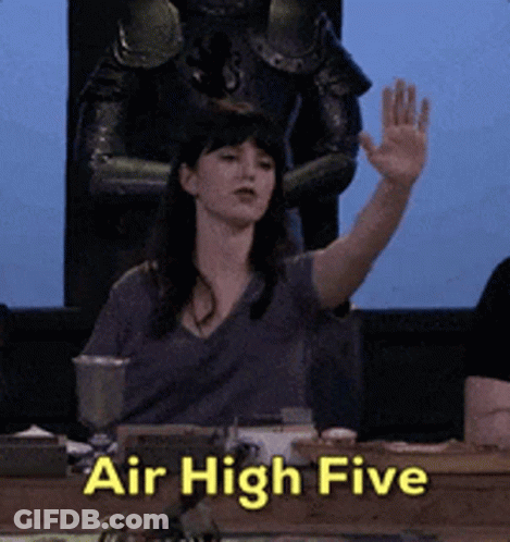 A Woman Sitting At A Table With Her Hand Up And The Words Air High Five GIF