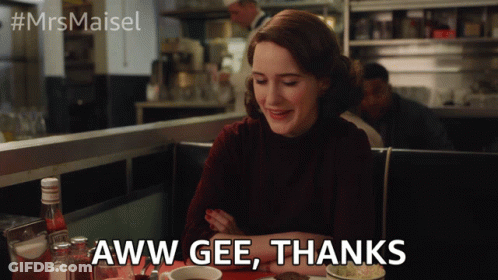 A Woman Sitting At A Table With The Words Aww Gee Thanks Written On The Screen GIF
