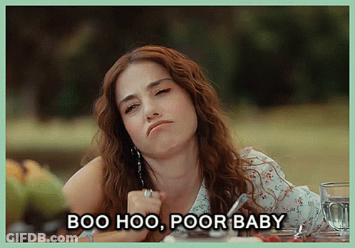 A Woman Sitting At A Table With The Words Boo Hoo Poor Baby Written Below Her GIF