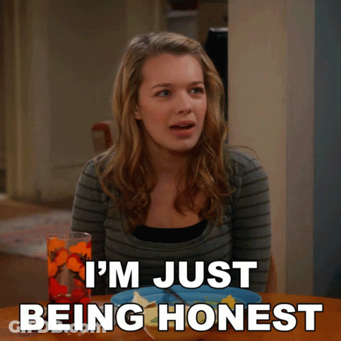 A Woman Sitting At A Table With The Words I 'M Just Being Honest Written Below Her GIF