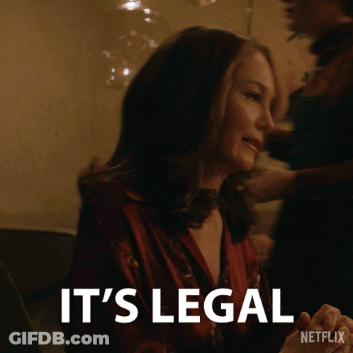 A Woman Sitting At A Table With The Words It 'S Legal On The Bottom GIF