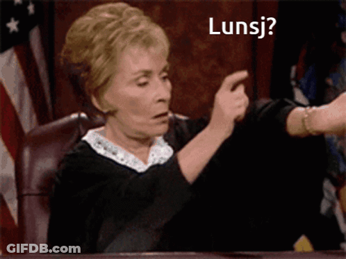 Woman Sitting At Table With Lunsj Sign GIF