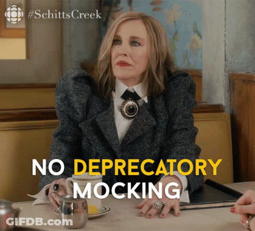 A Woman Sitting At A Table With The Words No Depredatory Mocking GIF