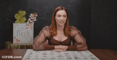 A Woman Sitting At A Table With The Words " No-One Is Complaining " Above Her GIF