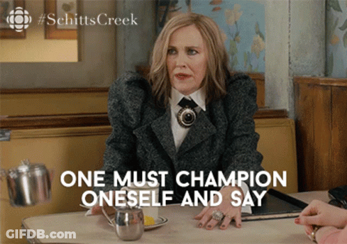 A Woman Sitting At A Table With The Words " One Must Champion Oneself And Say " GIF