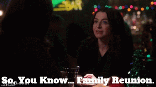 A Woman Sitting At A Table With The Words " So You Know Family Reunion " Above Her GIF