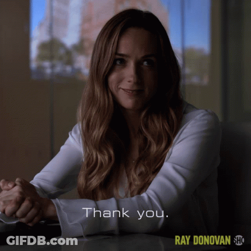 A Woman Sitting At A Table With The Words Thank You On The Bottom Right GIF