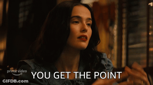 A Woman Sitting At A Table With The Words " You Get The Point " Written Below Her GIF