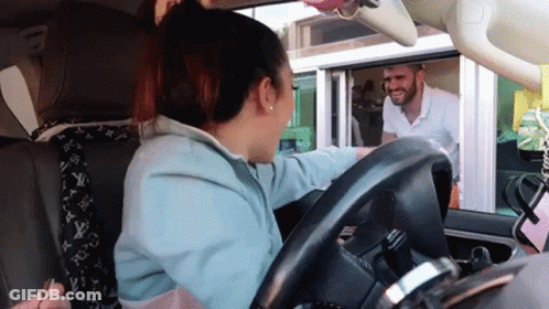A Woman Sitting In A Car Talking To A Man GIF