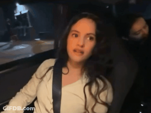 A Woman Sitting In A Car With A Seat Belt On GIF