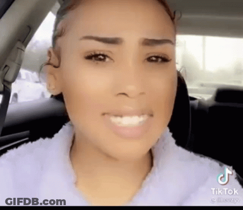 A Woman Sitting In A Car With A Tiktok Watermark On The Bottom Right GIF