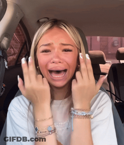 A Woman Sitting In A Car With Her Mouth Open Making A Face GIF
