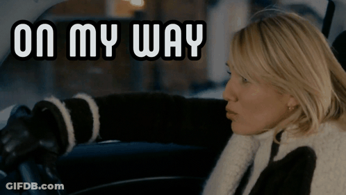 A Woman Sitting In A Car With The Words On My Way Behind Her GIF