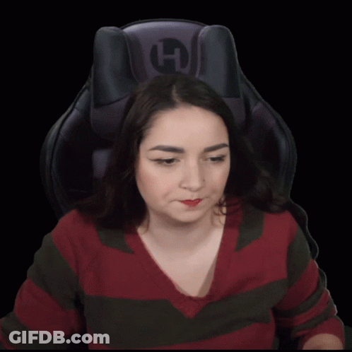 A Woman Sitting In A Chair Drinking From A Can With A Straw And The Letter H On The Back GIF