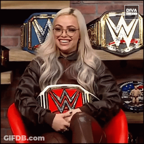 A Woman Sitting In A Chair Holding A W Belt GIF