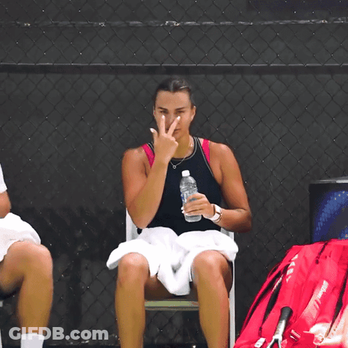 A Woman Sitting In A Chair With A Bottle Of Water GIF