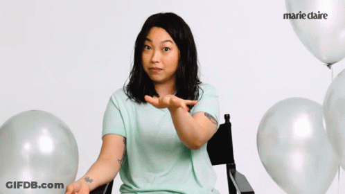 A Woman Sitting In A Chair With Balloons And Marie Claire On The Bottom Right GIF