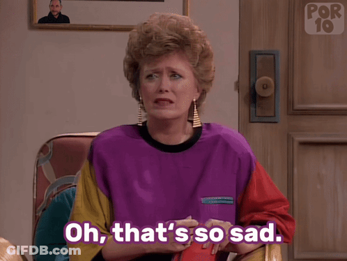 A Woman Sitting In A Chair With Her Hand On Her Face And The Words Oh That 'S So Sad Below Her GIF
