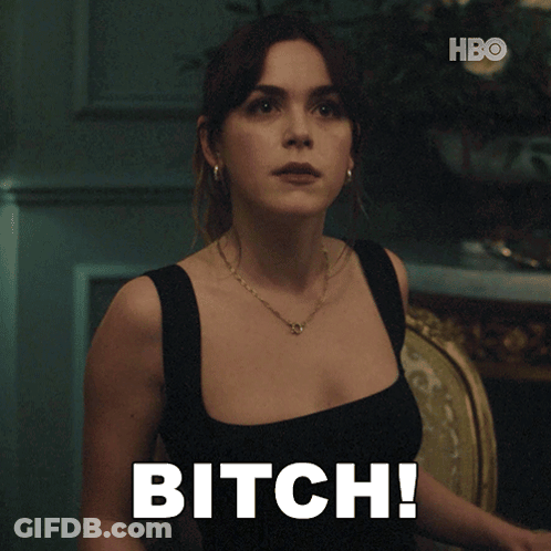 A Woman Sitting In A Chair With The Word Bitch Written On Her Chest GIF