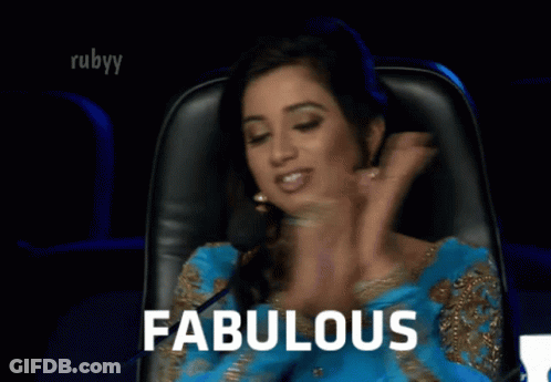 A Woman Sitting In A Chair With The Word Fabulous Written On The Screen GIF