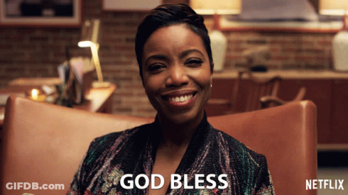 A Woman Sitting In A Chair With The Words God Bless Written On The Bottom GIF