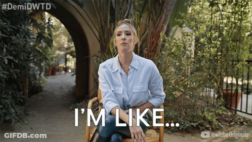 A Woman Sitting In A Chair With The Words I 'M Like Written Below Her GIF