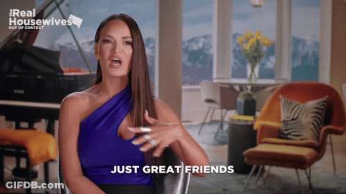 A Woman Sitting In A Chair With The Words Just Great Friends On The Screen GIF