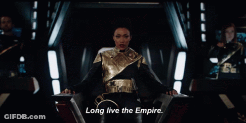 A Woman Sitting In A Chair With The Words Long Live The Empire On The Bottom GIF