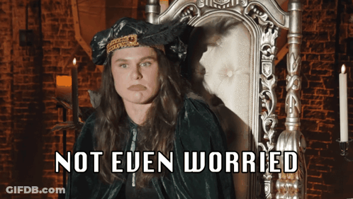 A Woman Sitting In A Chair With The Words " Not Even Worried " Written Below Her GIF