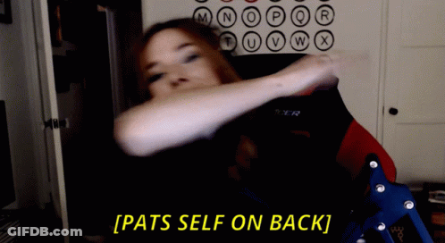 A Woman Sitting In A Chair With The Words Pats Self On Back Behind Her GIF