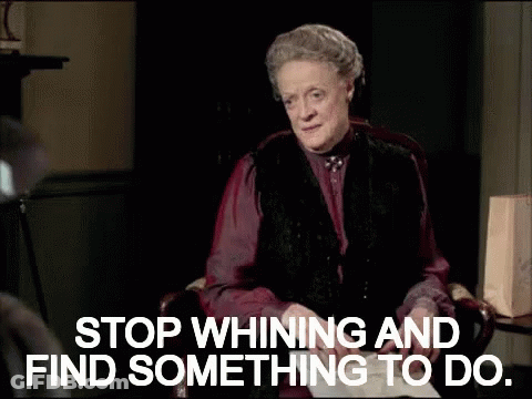 A Woman Sitting In A Chair With The Words " Stop Whining And Find Something To Do " GIF
