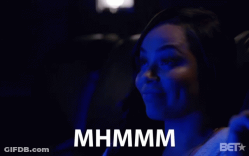 A Woman Sitting In A Dark Room With A Bet Logo On The Bottom Right GIF