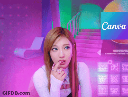 A Woman Sitting In Front Of A Canva Sign GIF